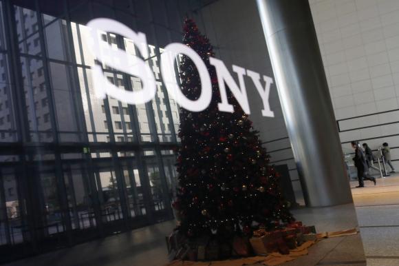 The logo of Sony Corp and a Christmas tree are reflected on the company's 4K television set at the company's headquarters in Tokyo